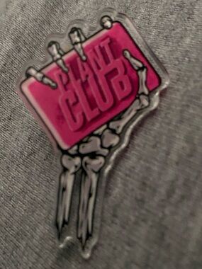 Plant Club collectible Pin featuring a skeleton hand holding pink bar of soap